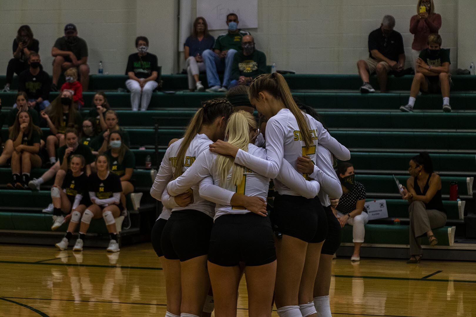 Girls Huddling before start of match MHS Volleyball